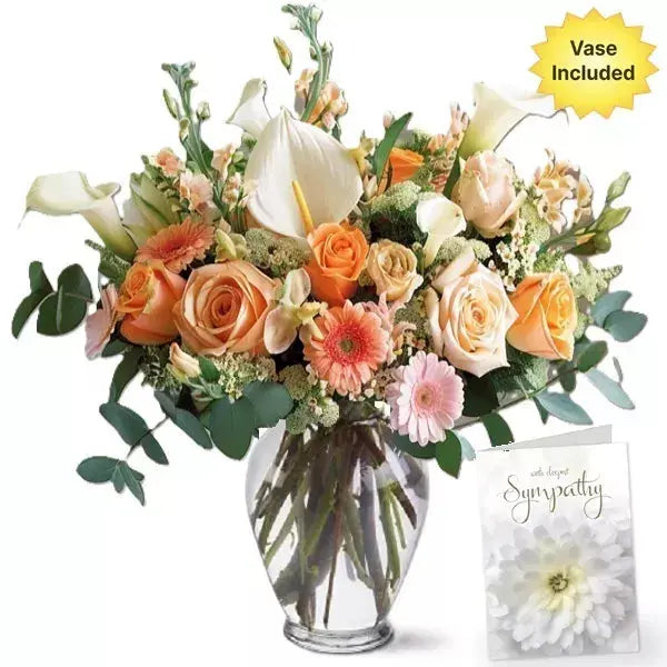 Bouquet of roses and lilies in a vase with a sympathy card.