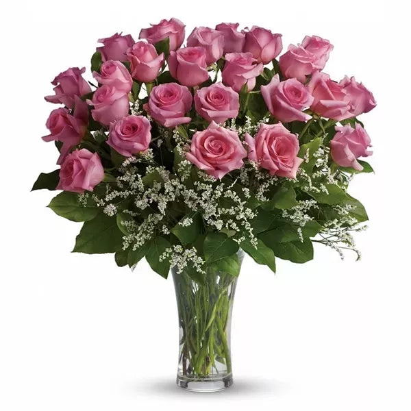 A bouquet of pink roses with baby's breath in a vase.