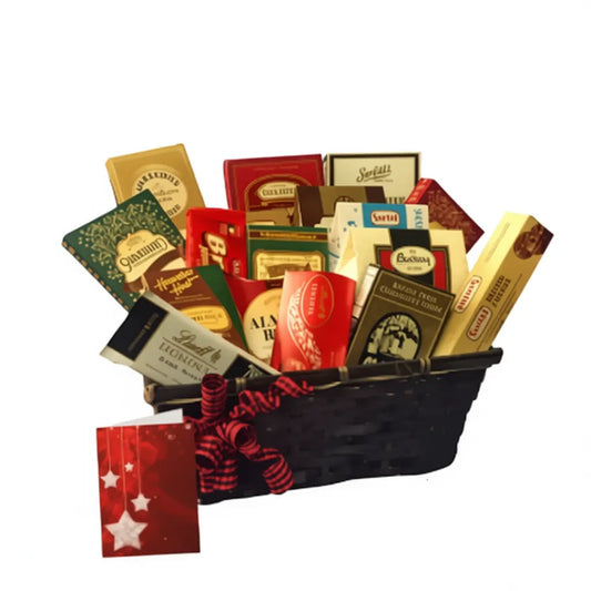 Christmas gourmet gift basket with assorted chocolates, truffles, and sweets in a black basket with red ribbon and holiday card.