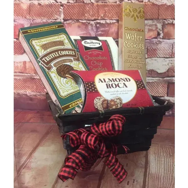 A basket of assorted treats including truffle cookies, chocolate chip cookies, wafers, and almond roca.