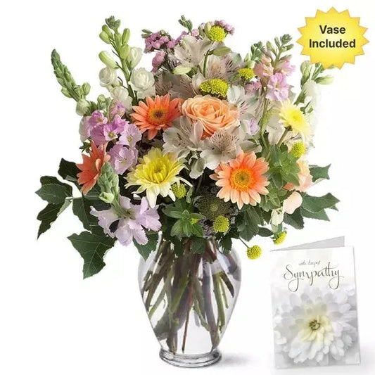A colorful bouquet with a 'With deepest Sympathy' card, vase included.