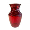 A red glass vase on a white background.
